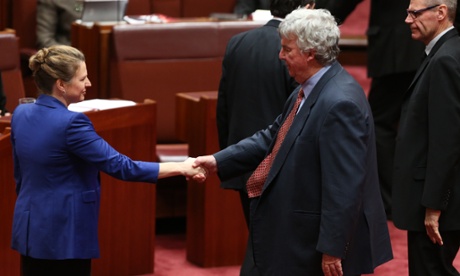 Western Australian senator Louise Pratt shakes hands with fellow outgoing conservative Nationals senator Ron Boswell from Queensland.