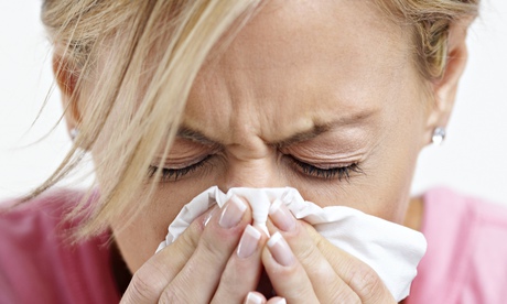 A woman sneezing