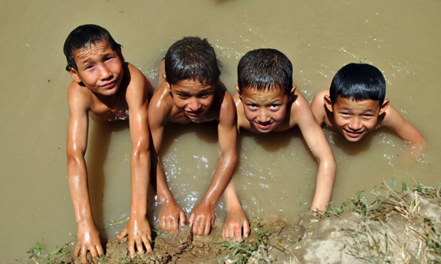 Αφγανός αγόρια κολυμπήσετε σε ένα κανάλι, όπως οι ίδιοι δροσερό στην επαρχία Μπαγκλάν του Αφγανιστάν