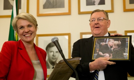 Former Nationals member for Hinkler Paul Neville receives a special gift from Labor's Tanya Plibersek.