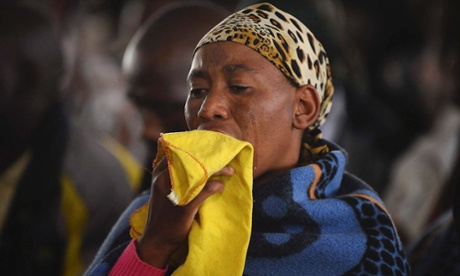 A relative weeps during a memorial service in honour of mineworkers killed by police in Marikana in South Africa.