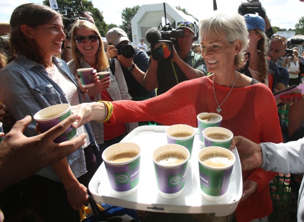 Judy Murray (right) serves coffee to spectators queuing for tickets during day three of Wimbledon