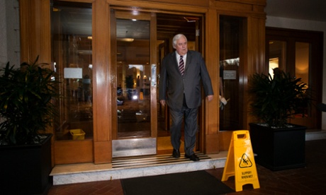 Slippery when wet: Clive Palmer leaves the Hyatt Hotel in Canberra for some vegemite toast with Tony Abbott.