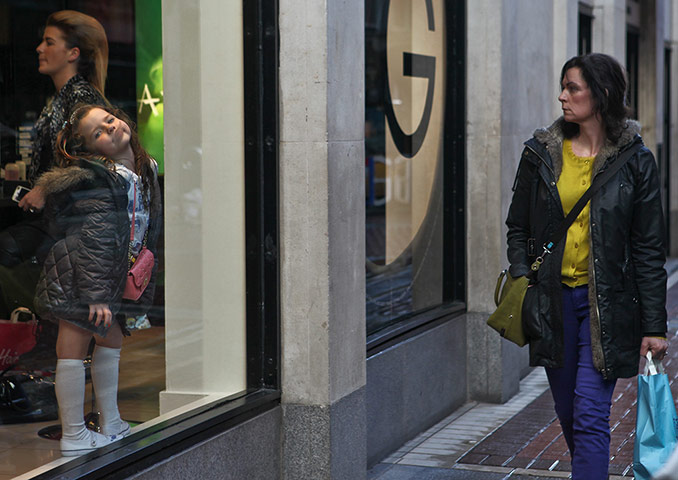 Your pictures: Woman walking past a shop window
