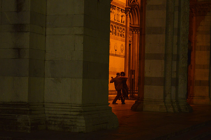 Your pictures: Couple doing tango inside the moonlit arches of a church