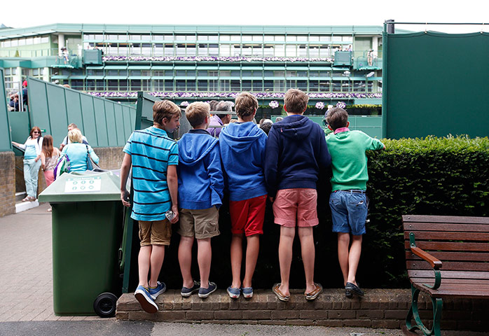 Wimbledon day four: Some youngsters try and get a glimpse of the action
