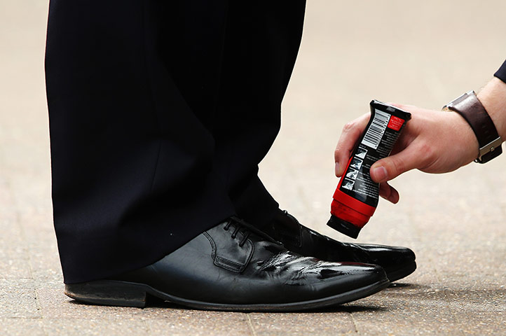Wimbledon day four: A steward has his shoes shined 