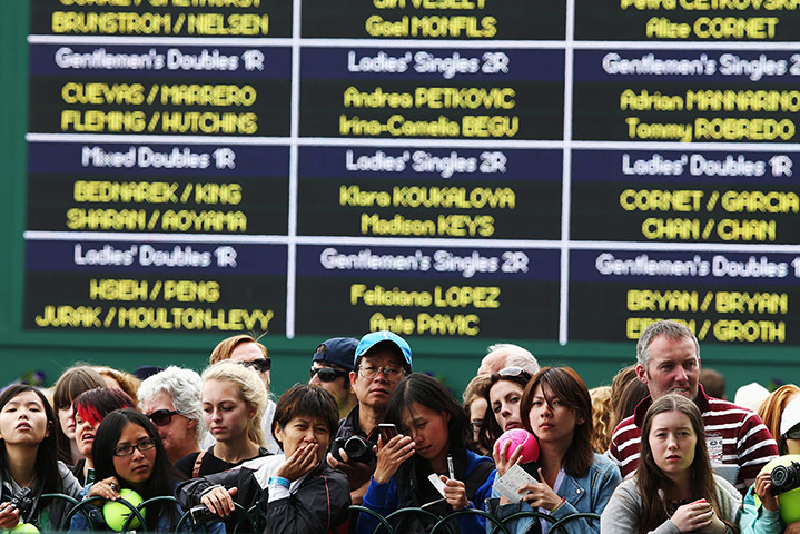 Wimbledon day four: Fans wait outside the practice courts