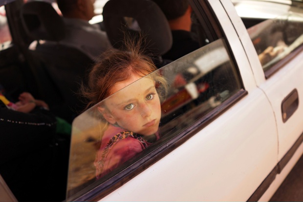 And also in that troubled region an Iraqi child looks out of the window of a car near Khazair, Iraq as she waits with her family to get into a temporary displacement camp for Iraqis caught up in the fighting in and around the city of Mosul. Khazair is now home to an estimated 1,500 internally displaced persons with the number rising daily.
