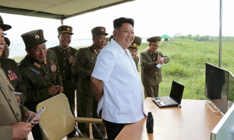 A propaganda photo said to show Kim Jong-un watching the guided missile test.