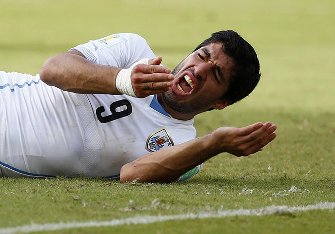20 Photos: Uruguay's Luis Suarez reacts after clashing with Italy's Giorgio Chiellini