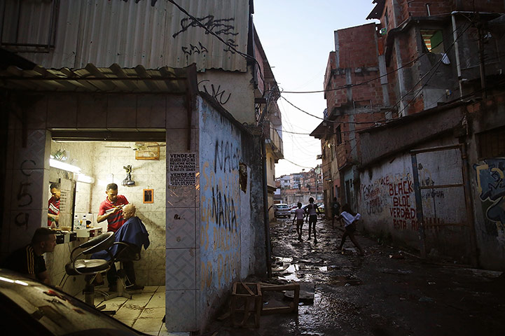20 Photos: A man receives a haircut in the Metro Mangueira favela