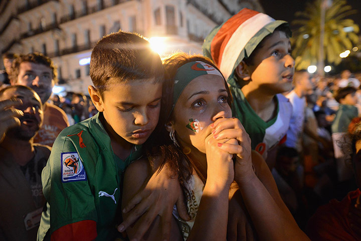 20 Photos: In Algiers, tense-looking fans watch the match between Algeria and Russia