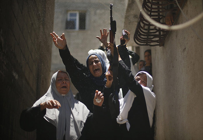 20 Photos: A relative of a member of Hamas' armed wing during his funeral in Gaza