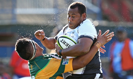 Fiji's Sunia Koto is tackled by Bon Maui of Cook Islands during the Rugby World Cup qualifying match