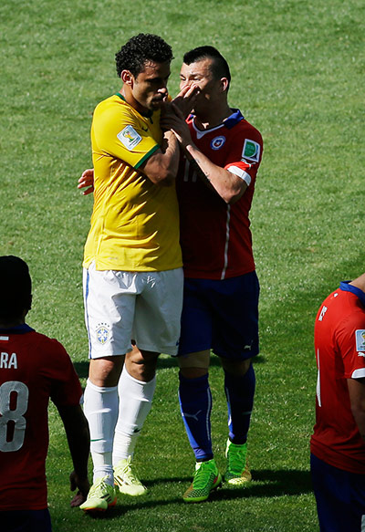 Brazil v Chile: Fred and Gary Medel argue at the end of the first half.
