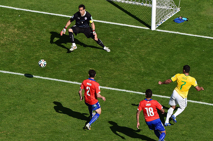 Brazil v Chile: Brazil's forward Hulk (R) kicks the ball