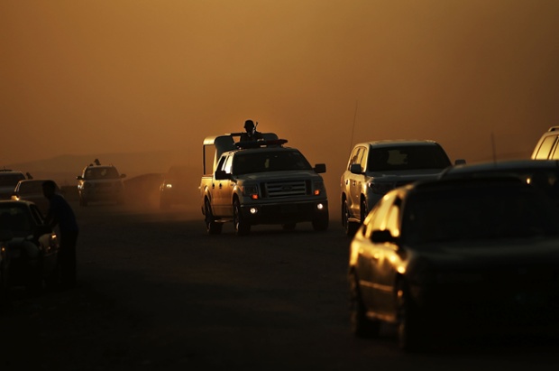 Members of the Peshmerga drive near of a displacement camp n Khazair, Iraq, for those caught up in the fighting in and around the city of Mosul.
