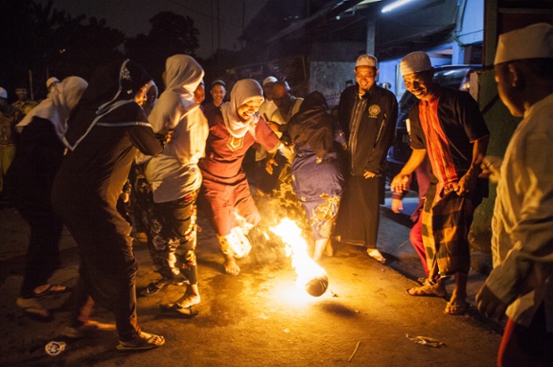 People play fire football to celebrate the beginning of the holy month of Ramadan in Jakarta, Indonesia.