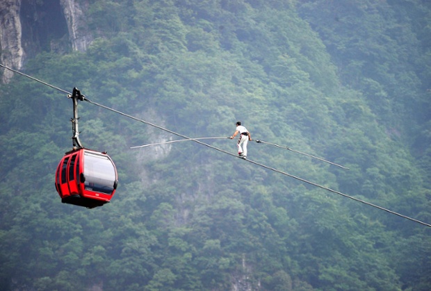 Swiss acrobat Freddy Nock attempts a tightrope walk over a mountain in the Tianmen Mountain National Park in China. He gave up just after halfway because of the steep inclination.