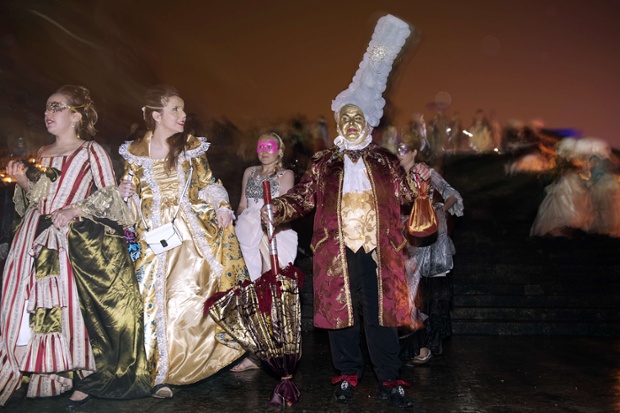 Guests arrive for the Great Masked Ball held in the gardens of the Palace of Versailles, France.