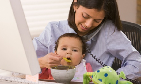 Hispanic mother feeding daughter and working Hispanic mother feeding daughter working 