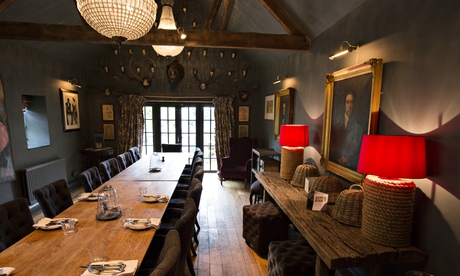 Long tables and hanging lamps at the Wheatsheaf Inn