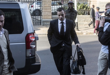 Oscar Pistorius (C) arrives in court in Pretoria this morning.