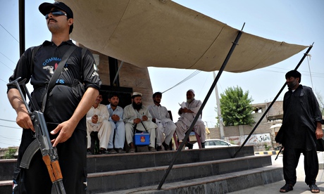 Police guard a polio vaccination team in Bannu 