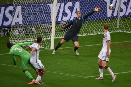 Germany's goalkeeper Manuel Neuer makes a save from Faouzi Ghoulam as Algeria press