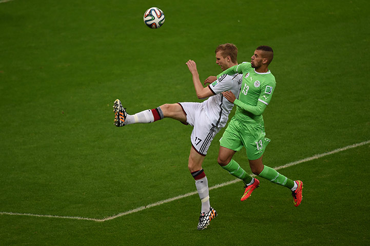 belo horizonte germany: Germany's defender Per Mertesacker challenged by Islam Slimani