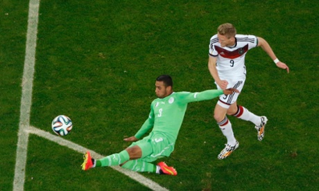 Algeria's Faouzi Ghoulam tackles Andre Schuerrle when he looked through on goal.