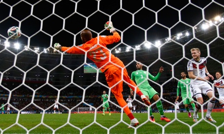 Andre Schuerrle of Germany scores his team's first goal past Algeria's 'keeper Rais M'Bolhi in extra time.