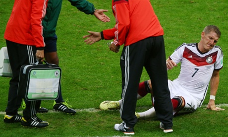 Bastian Schweinsteiger of Germany receives treatment for cramp.