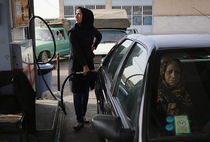 Agencies Iran Moore: a woman fills her gas tank