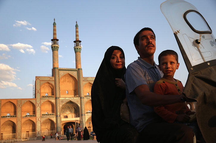 Agencies Iran Moore:  family on bike Amir Chakhmaq Hosseinieh worship site