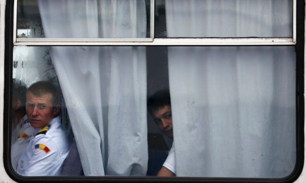 Romanian soldiers look out from a bus after the welcoming ceremony for U.S. Defence Secretary Chuck Hagel in the Black Sea port of Constanta.