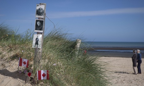 Canadian flags and portraits of Canadian soldiers Albert and Franck Maloney – killed here at Juno beach on June 6, 1944 – at Courseulles-sur-mer.