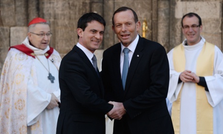 French Prime minister Manuel Valls (L) shakes hands with Australia's Prime Minister Tony Abbott (R) prior to a British D-Day commemoration ceremony at the cathedral in Bayeux, Normandy.
