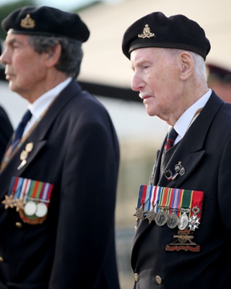 D-Day veteran Bill Price, aged 99, stands to attention at Gold Beach for the last ever flag-raising ceremony by the Surrey Normandy Veterans Association today in Arromanches.