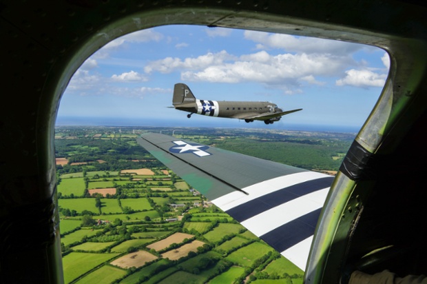 A DC-3 flies over Normandy in Sainte-Marie-Du-Mont, France.