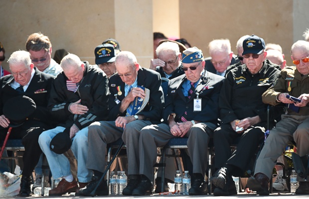 American veterans observe a minute of silence during a joint French-US D-Day commemoration ceremony at the Normandy American Cemetery and Memorial in Colleville-sur-mer, Normandy.