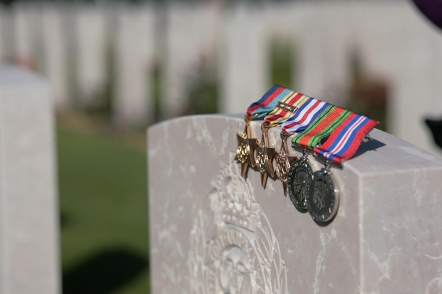 Medals lie on the grave at the Commonwealth War Graves Cemetery, Bayeux, Normandy, France.