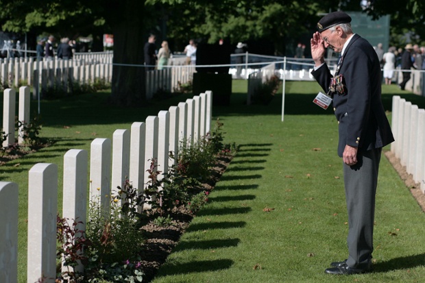 British WWII veteran Peter Smoothy salutes a fallen friend during the D-Day Normandy Landings 70th anniversary at the Commonwealth War Graves Cemetery, Bayeux, Normandy, France.
