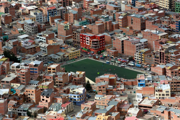 A football pitch surrounded by buildings in the middle of La Paz, Bolivia