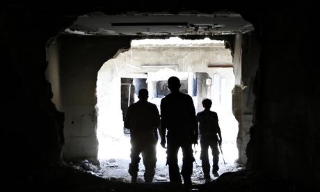 Free Syrian Army fighters walk in Aleppo