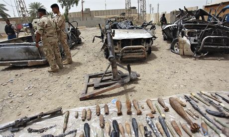 Iraqi security forces display vehicles, weapons and ammunition confiscated from militants