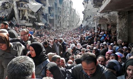 syria-residents-queue-to-receive-food-and-medical-aid