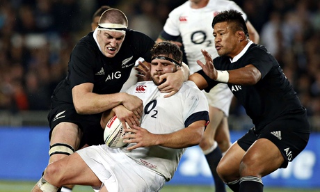 Rob Webber is tackled by Brodie Retallick, left, and Keven Mealamu in the first Test.