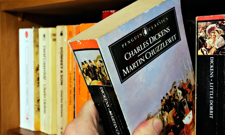 A hand taking Charles Dickens Martin Chuzzlewit  from a bookshelf